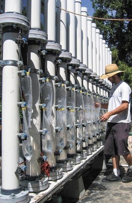 A UC Davis student participating in sand filtration research checks the status of several of the sand filters that remove pathogens from irrigation water. (photo: Loren Oki)