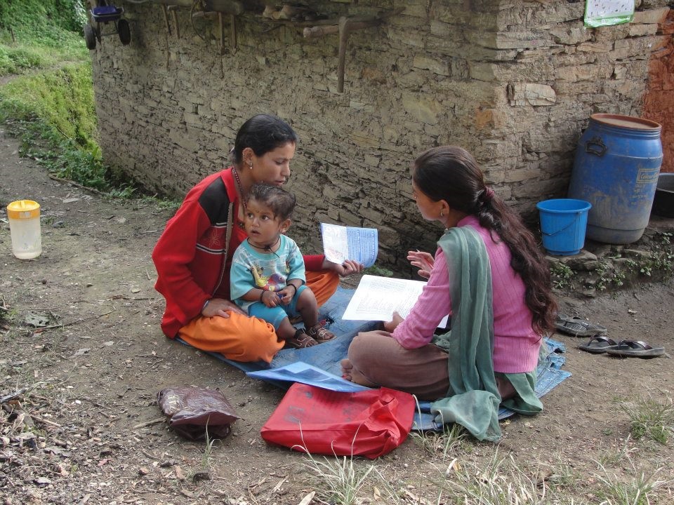 Women talking, with child