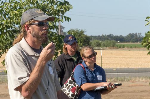 University of California weed scientist Brand Hanson talks about studies being conducted that simulated "spray drift" of various herbicides onto young walnut trees. (photo: Todd Fitchette/Western Farm Press)