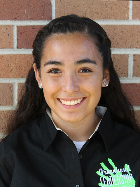 Close-up photo of a young woman, smiling