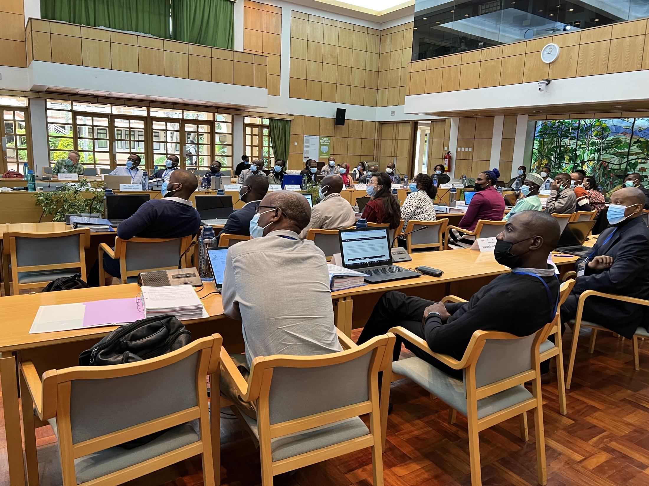 People sitting at rows of tables in a classroom