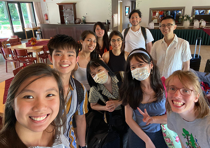 About eight young people smiling into the camera