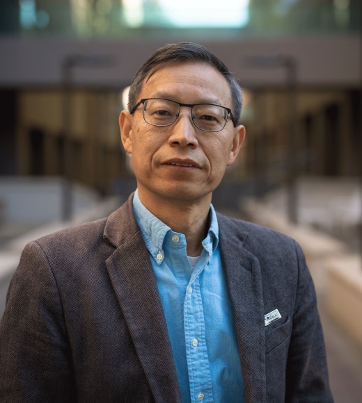 Man in suit poses for camera.