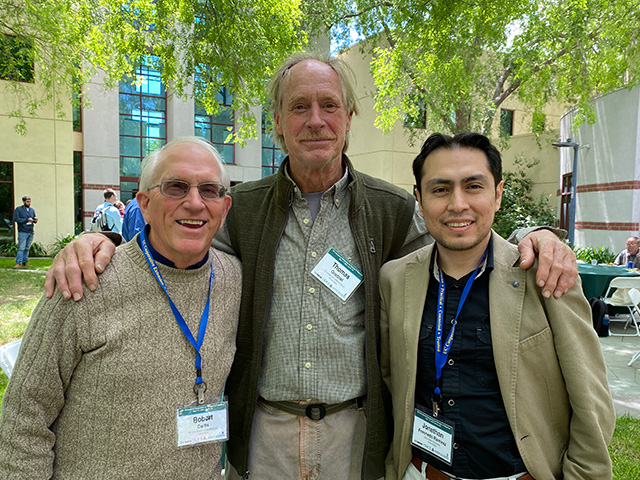 Three men standing outdoors