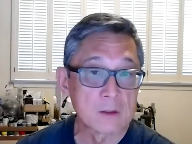 Man wearing glasses. You can tell he's on a video call.