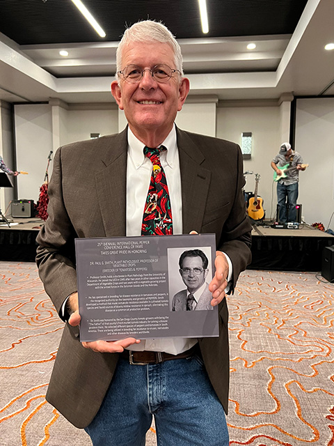 A man holding the same plaque.