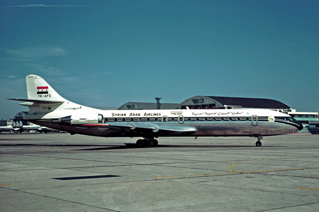 Old photo of a white, medium-small-sized airplane with oval windows.