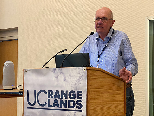 Man speaking at a podium. Sign on the podium says "UC Rangelands"