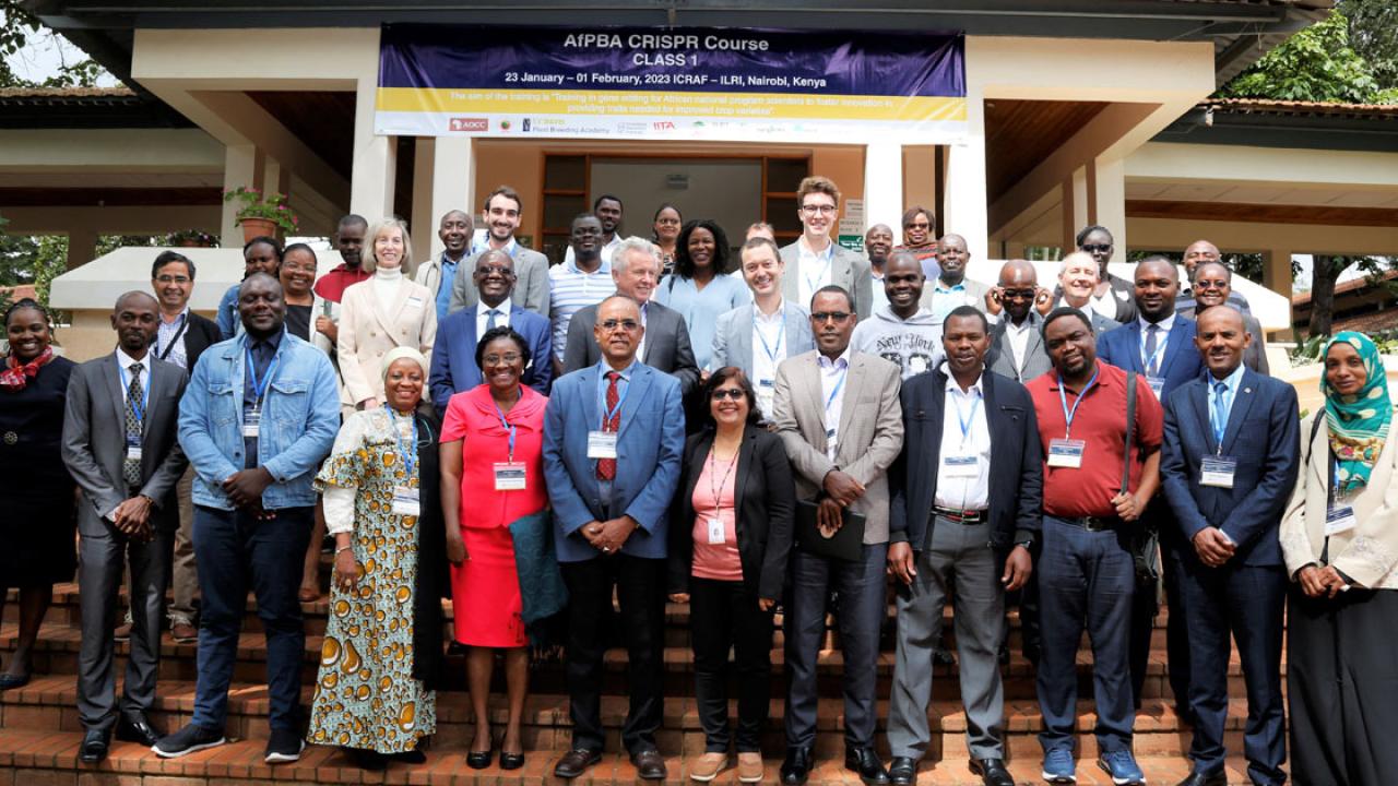 A large group of men and women in front of a building; above them reads "African Plant Breeding Academy CRISPR Course 1, January 2023"