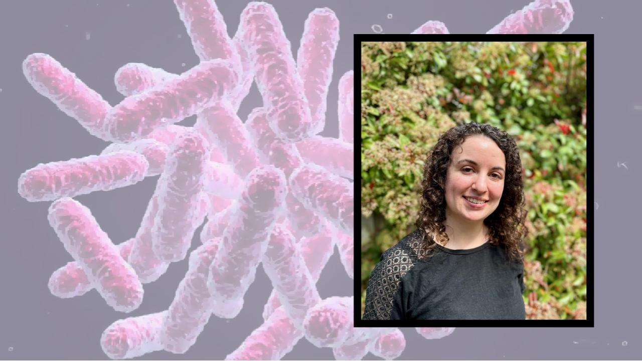 image of young woman, behind her is close-up of purplish, curvy things that look like fuzzy capsules