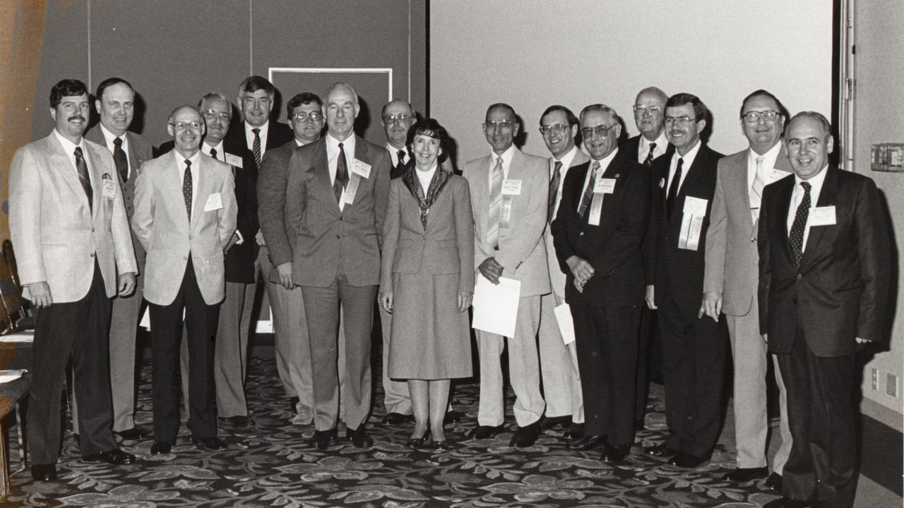 Barbara Webster stands center in a group of men