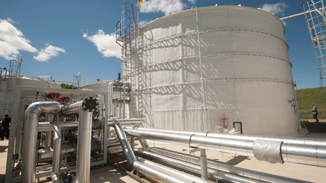 Large white industrial-looking structure, with large tubes and pipes.