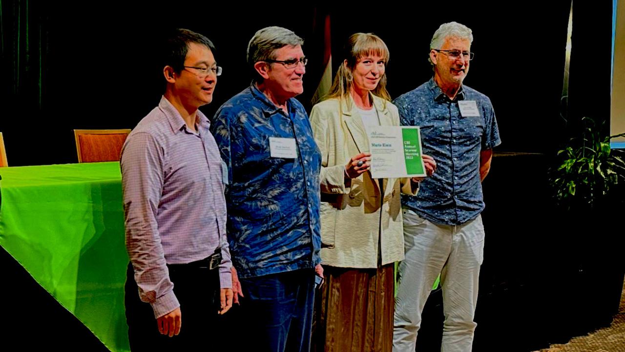 Four people standing on a stage