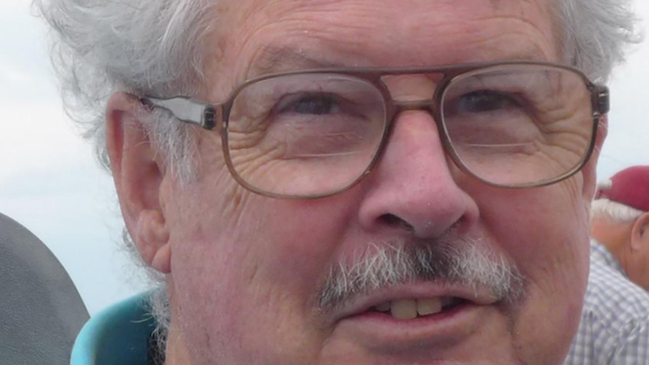 Lynn Gallagher, professor emeritus and barley breeder at the University of California, Davis, wears a half smile in a close-up portrait