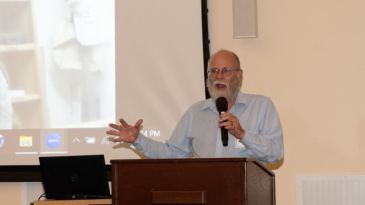 A man at a podium, speaking