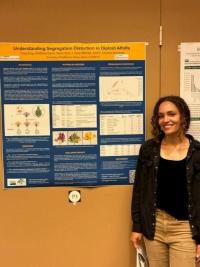 Woman standing next to a research poster.