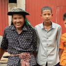 Cheang Sophat, left, and wife Hem Champa, far right, were able to send their second child to college after earning more money from vegetables grown in a nethouse. The couple is confident they will be able to send their third child, 14-year-old Phat Daroth, second from right, to college as well. (Max Fannin for UC Davis)