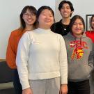 Seven young adults standing and smiling