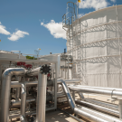 Large white industrial-looking structure, with large tubes and pipes.