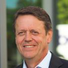 Headshot of Patrick Brown with a building as the background 