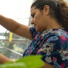 close-up of a woman in a lab with green plants