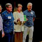 Four people standing on a stage