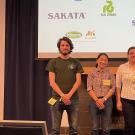 Five students in front of a screen with company names projected