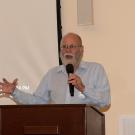 A man at a podium, speaking